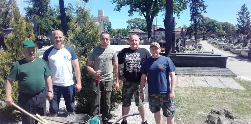 Prace pielęgnacyjne na grobach żołnierskich.